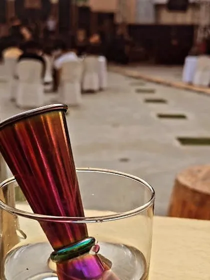 A detailed shot of a cocktail jigger and shaker on the bar before an event begins. This highlights our professional-grade equipment and readiness to serve.