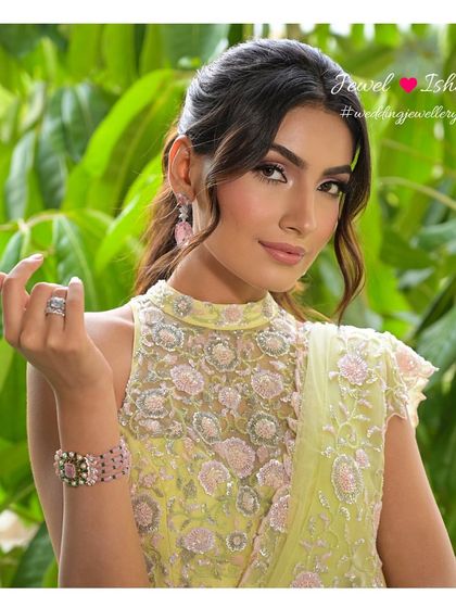 A close-up on the wrist, showcasing a beautiful pink morganite and diamond bracelet. It's a perfect piece for the bride who prefers understated elegance.