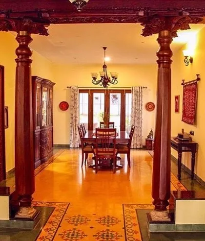 These traditionally carved wooden pillars in the Roopa Hariprasad Residence are a centerpiece of the home's design. We use such elements to ground our modern architectural work in the richness of Indian craft and heritage, creating a space that feels both timeless and personal.