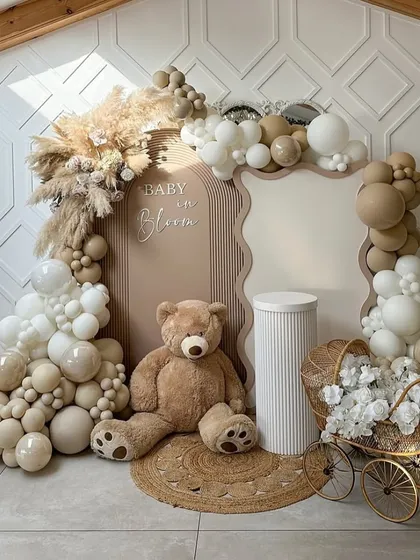 This "Baby in Bloom" baby shower decor is all about chic, neutral elegance. I used a palette of beige, white, and taupe balloons, combined with natural pampas grass, a large teddy bear, and a vintage-style pram to create a warm, sophisticated, and on-trend welcome for the new baby.