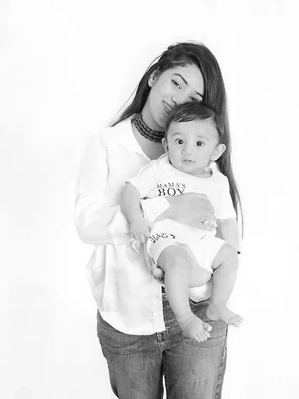 A mother's world in her arms. This classic black and white portrait beautifully captures the simple, pure love between a mother and her baby boy.