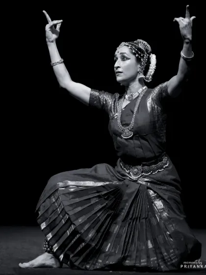 A black and white shot that emphasizes the sculptural quality of the pose and the intensity of the expression.