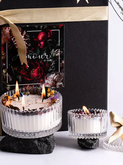 The Classic Duo candles, lit and glowing. This set of two crystal-cut glass jar candles makes for a stunning and elegant gift.