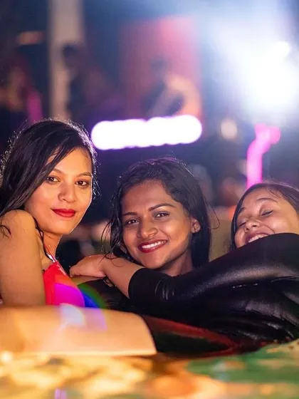 Friends enjoying the water and the party atmosphere after dark.