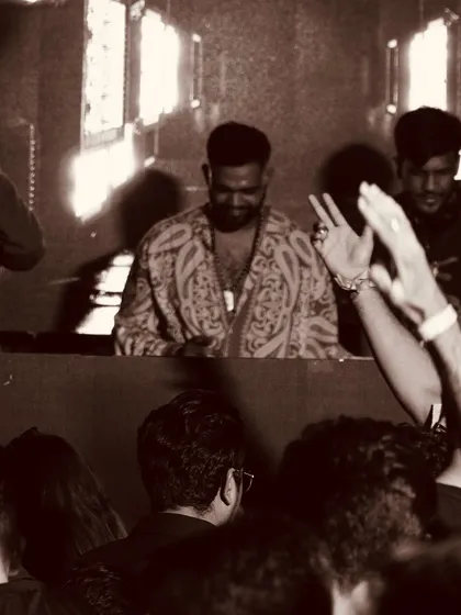 A vintage-style, sepia-toned photo of me at the decks, giving a classic, timeless feel to the club experience.