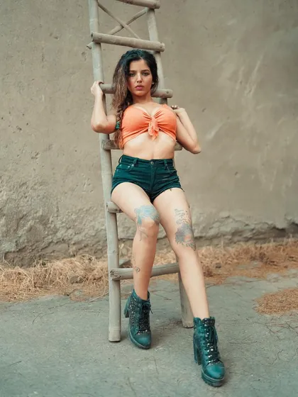 This pose shows off the full styling of the shoot, from the boots to the tattoos. It’s a great example of how we can build a complete look around a simple concept.