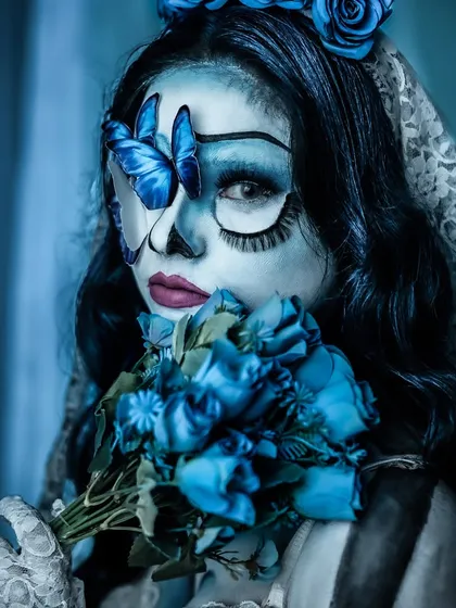 A direct and piercing look from the Corpse Bride. The makeup transforms the model completely, showcasing the power of fantasy makeup artistry.