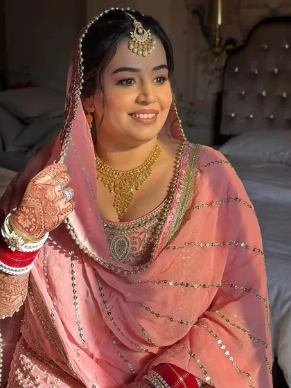A happy, glowing bride. The sunlight catches the soft shimmer in her makeup, making her look absolutely radiant.