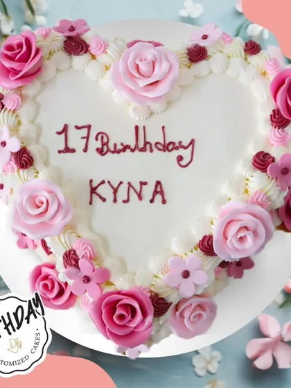 A heart-shaped floral cake for Kyna's 17th birthday. The cake is framed with a border of pink buttercream roses, making it a sweet and romantic celebration cake.