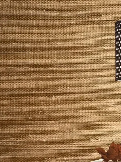 A close-up of a natural fiber wallcovering from the Intuition collection. The woven texture adds depth and a tactile quality to the wall, creating a cozy and high-end feel.