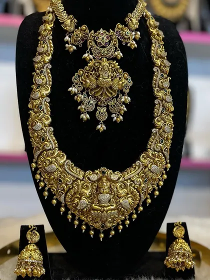 A heavy, ornate bridal set with a wide haram and matching choker. The design is perfect for making a statement on your wedding day.