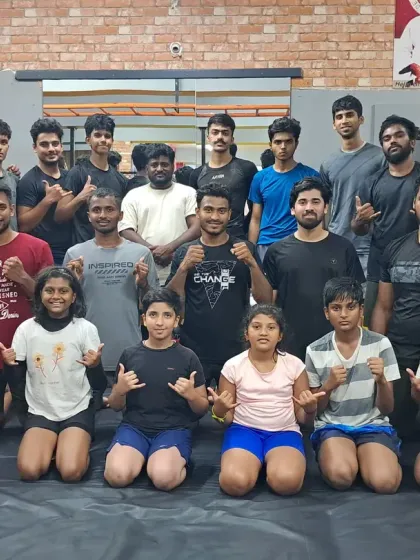 This is our family. After the sweat, the drills, and the hard rounds, we are one team. This photo captures the mix of men, women, and kids, from beginners to pros, who make up our diverse and supportive community. We train together, we grow together.