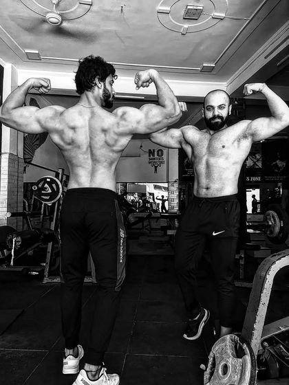 Posing with a training partner. The stage is calling, and we are getting ready together.