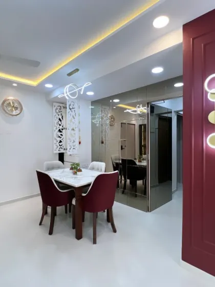 The strategic placement of mirrors and lighting creates depth and drama in this dining space, making it feel both grand and intimate.