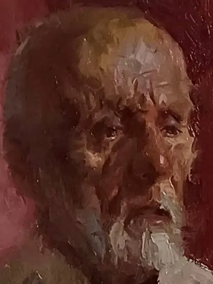 A close-up of a portrait demonstration done in Pune. The red background creates a strong contrast with the subject's face.