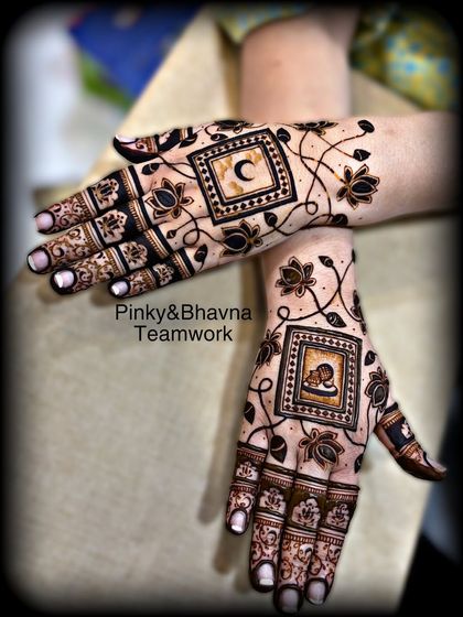 A unique Karwachauth design featuring the moon on one hand and a portrait on the other, connected by a delicate floral vine.
