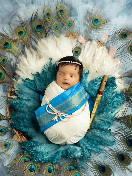 This serene newborn portrait features a 'Little Krishna' theme, complete with a peacock feather nest and traditional details. I specialize in creating these safe and artistic setups to celebrate your baby's first few days.