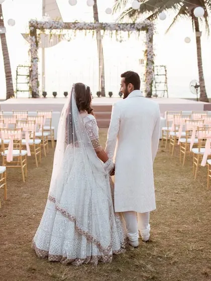 Your dream destination wedding deserves an epic backdrop. Here, we captured the couple just before their beachside ceremony in Juhu, a serene moment before they say 'I do'.