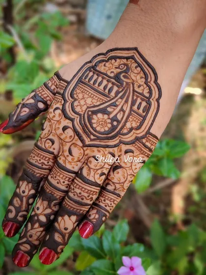 A close-up of a single hand with a large, framed paisley design, perfect for a party.