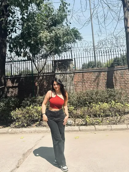 A recent fit featuring a one-shoulder red top and black jeans. This is a great example of a simple but eye-catching casual outfit.