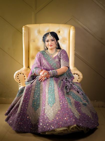 A classic seated portrait of the bride-to-be, showcasing her elegant engagement outfit.