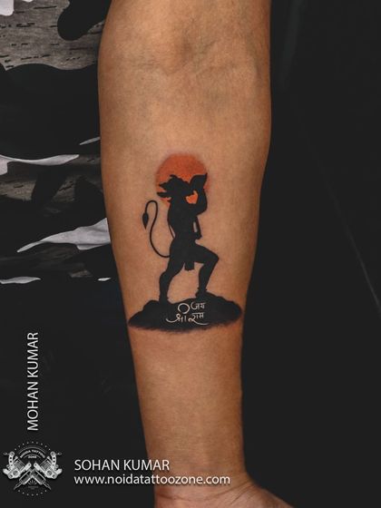 A silhouette of Lord Hanuman carrying the Dronagiri mountain, set against an orange sun. This is a powerful and minimalist way to depict a famous story, using solid black and a pop of color.
