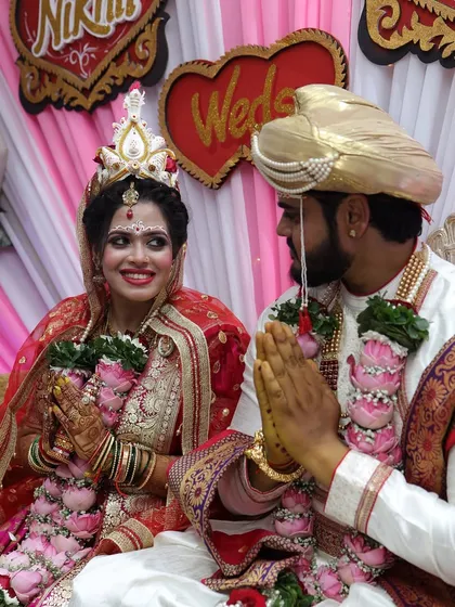 The complete Bengali wedding look, with the groom in his traditional 'topor'. This captures a beautiful moment from the ceremony.