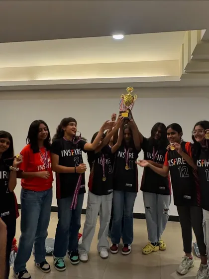 The result of discipline and hard work. Our girls' team celebrating another victory, holding the trophy high. We train to compete, and we compete to win.