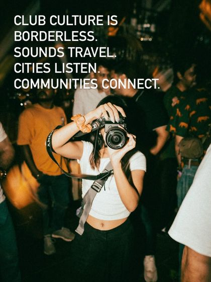 A photographer captures the moment amidst a packed crowd. Our events are a hub for creatives and the community, a place where culture is not just consumed but also created.