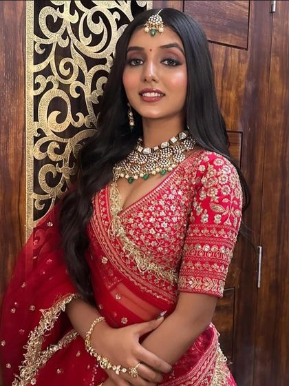 A closer look at our classic red bridal lehenga. The intricate gold embroidery on the blouse and the sheer net dupatta with a detailed border create a look of pure elegance.