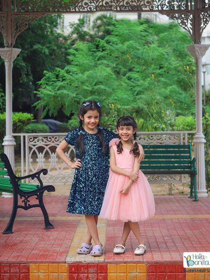 Two sisters, best friends for life. This outdoor portrait captures their sweet bond in a beautiful park setting with a classic gazebo in the background.