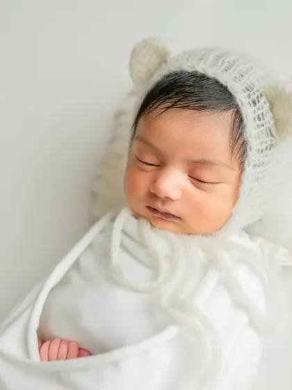 Another angle of the white wrap pose, showing the baby's tiny hand peeking out.