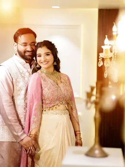 A bright and happy couple portrait from a Roka ceremony, with a beautiful lens flare adding a touch of magic.