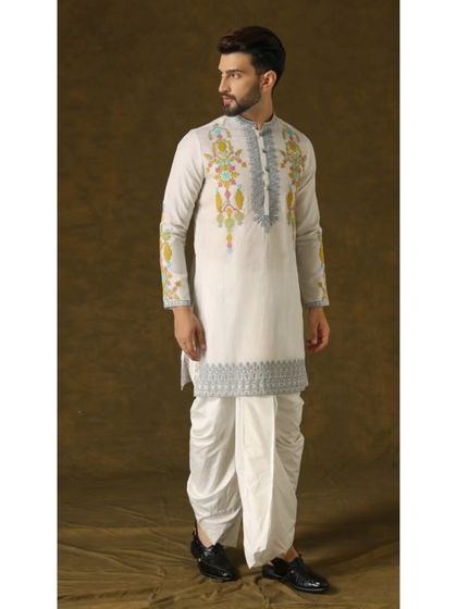 A side profile of the 'Narayan Nirvana' set, showcasing the elegant silhouette and the detailed embroidery on the hem of the kurta.