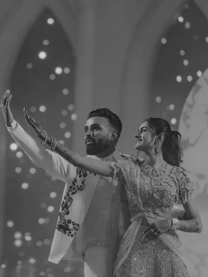 A classic black and white shot of the couple dancing. It captures a moment of grace and connection, proving that elegance is always in style.