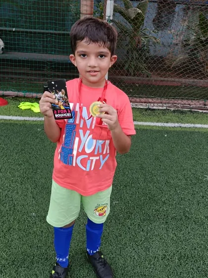 Another happy Player of the Month, showing the rewards of hard work and good sportsmanship.