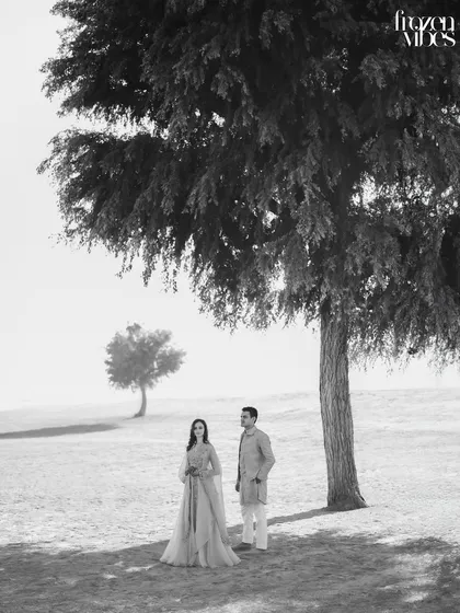 The black and white version of the minimalist desert shot. Stripping away the color emphasizes the beautiful textures of the sand and trees, and the quiet connection between Saloni and Kanav.