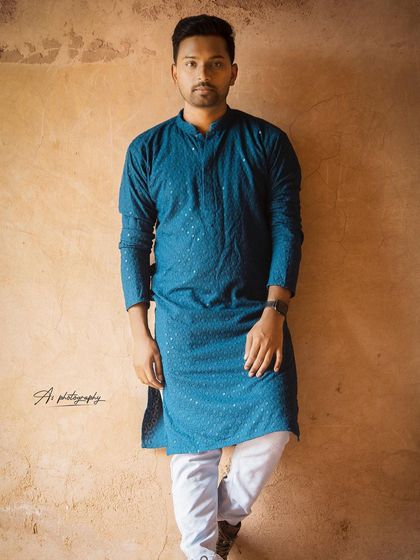 A full-length portrait of a model in a modern blue kurta. This shot shows versatility by including ethnic wear in a portfolio, perfect for festive season campaigns or traditional roles.