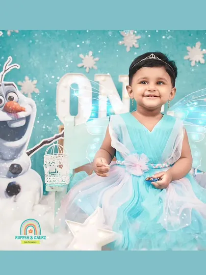 Welcome to a winter wonderland. We had so much fun creating this 'Frozen' themed first birthday shoot, complete with a smiling Olaf and a magical castle backdrop for a little princess.