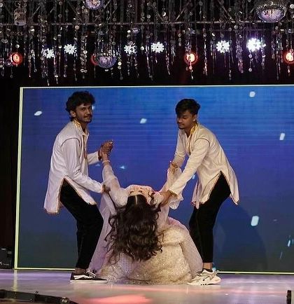 A duplicate of image 19, this shot captures the trust and coordination between the bride and her backup dancers during a key moment in the choreography.