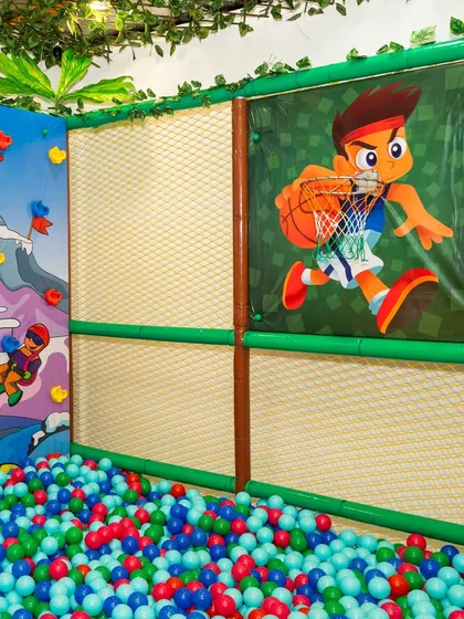 The ball pit area also features a mini basketball hoop, adding another layer of interactive fun for the kids.