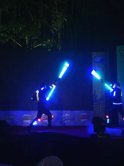 For an SBI event with a superhero theme, I had my performers use glowing blue light staffs to create a futuristic sword-fighting sequence. This shows how I can adapt my LED shows to fit any creative concept, making the entertainment a core part of the event narrative.