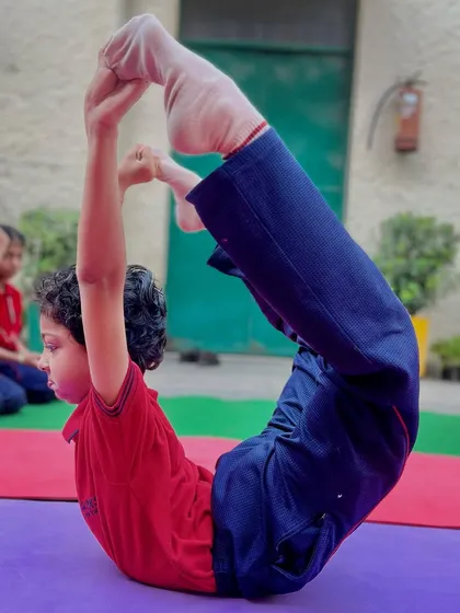 The Dhanurasana, or Bow Pose, strengthens the back and improves posture. This young student shows a perfect form.
