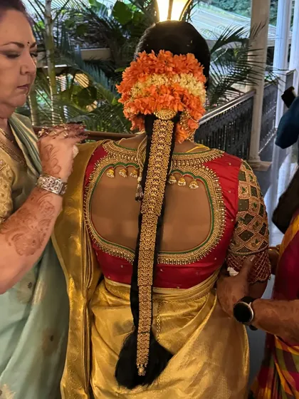 The artistry is in the details. A traditional South Indian bridal braid, or *mogginajade*, is a masterpiece in itself. Here, I've used fresh flowers and a classic gold *jadai* to create a timeless and elegant hairstyle from the back.