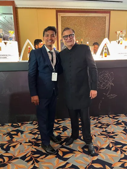 It's an honor to serve distinguished guests at weddings. Here I am with a guest in front of our elegant bar setup.