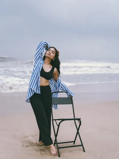 A standing pose with the chair, creating strong lines and a powerful silhouette against the moody sky.