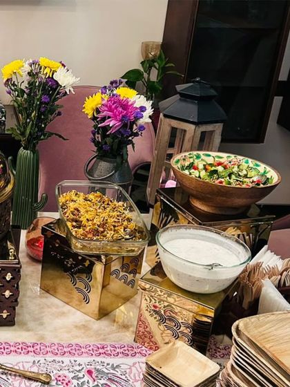 A home party setup featuring a mix of serveware, including glass bowls for salads and my signature golden boxes as risers. This shows how I creatively use space to present a full buffet in a home setting.