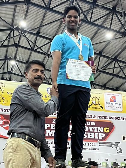 Jonathan receiving his medal on the podium at the Tumkur competition.