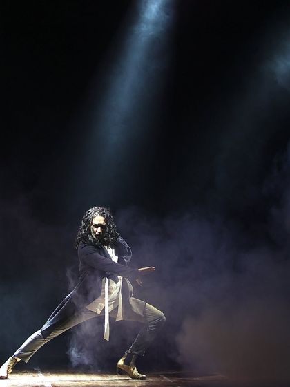 A dramatic solo performance, with smoke and spotlights creating a theatrical atmosphere.
