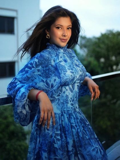 This blue floral high-neck dress with balloon sleeves is a sophisticated yet comfortable choice. The flowing fabric and soft print make it an easy-to-wear piece that still looks put-together.